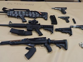 Assault rifles, a shotgun and loaded handguns were found inside a suspected drug house in South Surrey