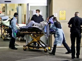 One of the survivors of Thursday night's triple shooting in Burnaby is wheeled into the emergency department at Royal Columbian Hospital.