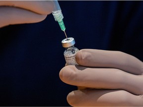 A healthcare worker prepares a dose of the Pfizer/BioNTech COVID-19 vaccine.
