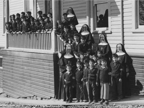 Catholic church officials with Indigenous children outside the St. Paul's Indian Residential School in North Vancouver.