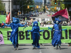 Several dozen supporters of the environmental group Extinction Rebellion occupy the intersection of Granville and Georgia Streets in Vancouver, B.C. Saturday, May 1, 2021. The event kicks-off five days of 'Spring Rebellion' by the group who are calling for changes to society's attitudes toward the environment.