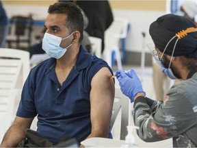 People in the 30-and-older age group receive a Covid-19 vaccination from nurses at the Dukh Nivaran Sahib Gurdwara in Surrey, BC Friday, May 7, 2021.