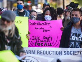 Several dozen protestors march through the Downtown Eastside of Vancouver, BC Tuesday, May 11, 2021 calling for a safe supply of street drugs.