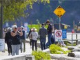 File photo of people enjoying a May stroll at Ambleside Park in West Vancouver.