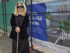 Laura Mackenrot, a member of Vancouver's persons with disabilities advisory committee, stands outside the construction site of the future Oak-VGH subway station in Vancouver.