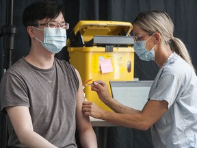 People receive their COVID-19 vaccination at the Vancouver Convention Centre on Friday, May 14, 2021.