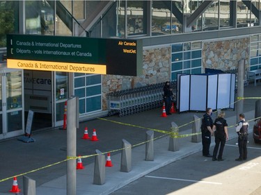 Police investigate a shooting at YVR in Richmond, BC, May 9, 2021.