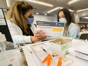 Nurse Jessie Uppal administers a shot to Jacqueline Mota as thousands got their vaccine shot at Vancouver Convention Centre .