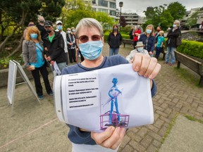 Maggie Rayner holds up a photo of proposed sculpture called Teal Boy Sculpture at the north end Moberly Road in Vancouver.