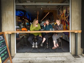 People enjoy eating/drinking inside restaurants, cafes and bars like Alphabet City in Vancouver on Sunday after six weeks of restrictions.