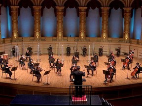 A masked-up Vancouver Academy of Music Symphony Orchestra records at the Orpheum Theatre.