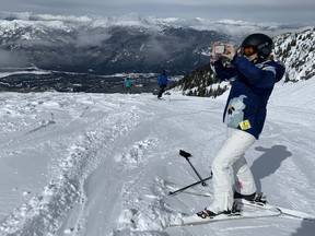 Maureen Cureton takes a photograph during a stop while skiing at Whistler in a submitted photo.