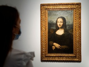 A woman looks at the Hekking "Mona Lisa", a reproduction of Leonardo Da Vinci's Mona Lisa, painted on canvas by an unknown artist from the 17th century.
