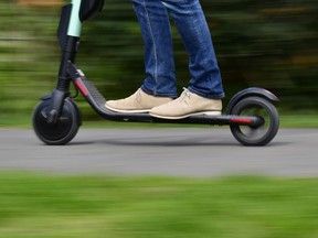 File photo of a man riding an e-scooter.