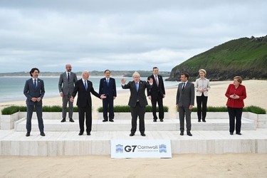 (L-R) Canadian Prime Minister Justin Trudeau, President of the European Council Charles Michel, US President Joe Biden, Japanese Prime Minister Yoshihide Suga, British Prime Minister Boris Johnson, Italian Prime Minister Mario Draghi, French President Emmanuel Macron, President of the European Commission Ursula von der Leyen and German Chancellor Angela Merkel, pose for the Leaders official welcome and family photo during the G7 Summit In Carbis Bay, on June 11, 2021 in Carbis Bay, Cornwall. UK