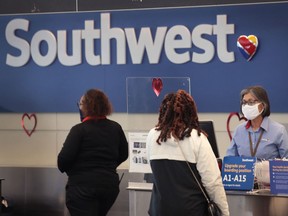 Passengers check in for Southwest Airlines flights at Midway International Airport in Chicago, Illinois. In January, Southwest Airlines reported its first annual loss since 1972. The pandemic has wreaked havoc on the industry in 2020 with U.S. airlines reporting a combined $34 billion loss.