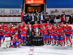 Montreal Canadiens players pose with the club’s first Clarence S. Campbell Bowl trophy ever — it’s been traditionally awarded to the Western Conference playoff winner — after beating the Vegas Golden Knights in Game 6 of their Stanley Cup semifinal series on Thursday at the Bell Centre in Montreal.
