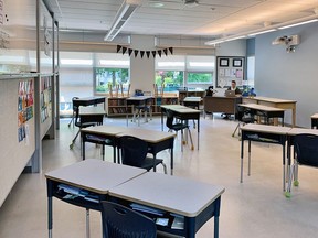 A classroom at L'Ecole Bilingue in the Vancouver school district has desks spaced out and many student chairs removed.  Teacher Brianne Fenrich, seated. Mandatory credit: Vancouver school district [PNG Merlin Archive]