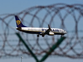 An airplane of Irish airline Ryanair approaches the BER airport near Berlin Schoenefeld on May 31, 2021.
