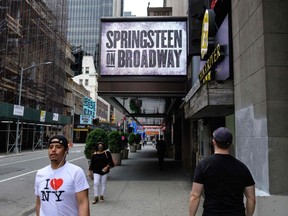 People walk past the St. James Theatre after it announced Bruce Springsteen's return to Broadway on June 26th with 'Springsteen on Broadway' on June 11, 2021 in New York City.