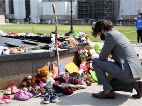 Canadian Prime Minister Justin Trudeau visits the makeshift memorial erected in honor of the 215 indigenous children remains found at a boarding school in British Columbia, on Parliament Hill June 1, 2021 in Ottawa.