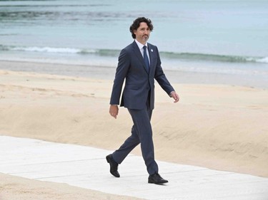 Canada's Prime Minister Justin Trudeau walks along the beach at the start of the G7 summit in Carbis Bay, Cornwall on June 11, 2021.