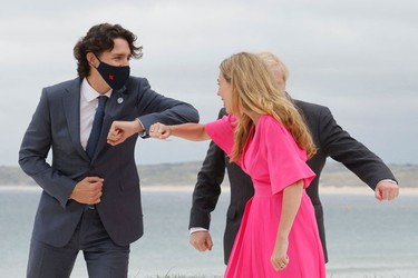 Britain's Prime Minister Boris Johnson (R) and his wife Carrie Johnson welcome Canada's Prime Minister Justin Trudeau prior to the start of the G7 summit in Carbis Bay, Cornwall on June 11, 2021. -