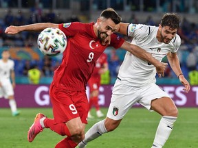 Turkey's forward Kenan Karaman (L) vies with Italy's midfielder Manuel Locatelli during the UEFA EURO 2020 Group A football match between Turkey and Italy at the Olympic Stadium in Rome on June 11, 2021.