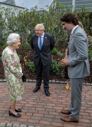 Canada's Prime Minister Justin Trudeau (R) speaks with Britain's Queen Elizabeth II (L) at a reception with G7 leaders at The Eden Project in south west England on June 11, 2021.