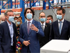 Canadian Prime Minister Justin Trudeau looks up during a tour of pharmaceutical company Pfizer with Belgian counterpart Alexander De Croo (R) in Puurs, Belgium June 15, 2021. Frederic Sierakowski/Pool via REUTERS