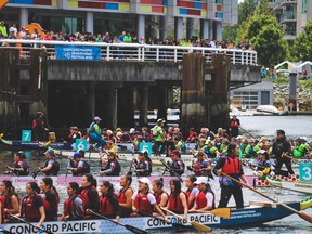 Spectators crowd the railings as teams cross the finish line at the 2019 Concord Pacific Dragon Boat Festival.