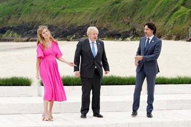 Britain's Prime Minister Boris Johnson, his spouse Carrie Johnson and Canada's Prime Minister Justin Trudeau pose for a photo during the G7 summit in Carbis Bay, Cornwall, Britain, June 11, 2021.