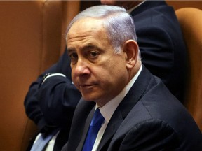 Israeli Prime Minister Benjamin Netanyahu looks on during a special session of the Knesset, Israel's parliament, whereby a confidence vote will be held to approve and swear-in a new coalition government, in Jerusalem June 13, 2021.