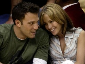 Ben Affleck gets a smile from girlfriend Jennifer Lopez during the Los Angeles Lakers San Antonio Spurs NBA Western Conference semifinal in Los Angeles May 11, 2003.