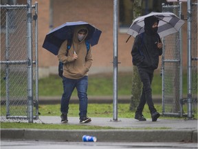 Students wearing masks leave Queen Elizabeth Secondary school in Surrey, BC Thursday, February 4, 2021.