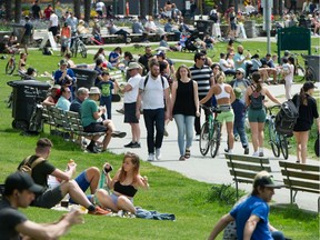People enjoy the weather at English Bay in Vancouver, B.C., May 10, 2020.