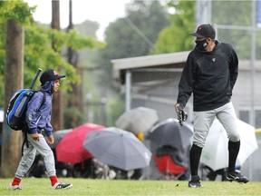 A Hastings Community Little League player prepares to play in the rain in Vancouver, BC., on June 6, 2021.