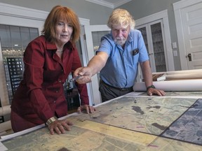 Amy Newman and Richard Wright looking over maps of where the Cariboo Waggon Road was located.