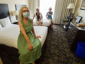 Catherine Stafford and friends Lily Shinde and Vichy Miu sit inside Catherine's suite at the Park Inn and Suites in Vancouver. Lack of air conditioning and fans has many seniors struggling during this heat wave.