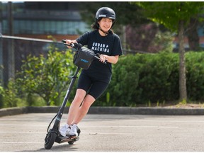 Nancy Mo rides an electric scooter in Vancouver on July 6, 2020.
