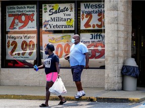 FILE PHOTO: Shoppers leave a Piggly Wiggly supermarket in Columbus, Georgia, on September 8, 2020.