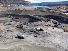 In the area between the two coffer dams, crews excavate and prepare the dam core area, in June 2021, where the earthfill dam will be constructed.