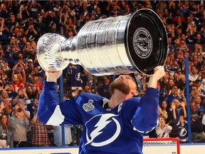 Tampa Bay Lightning captain Steven Stamkos hoists the Stanley Cup after beating the Montreal Canadiens on Wednesday at Amalie Arena in Tampa, Fla.