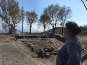 Angie Thorne points to where her lilac bushes used to be at her home on the Ashcroft First Nation reserve. Her home was destroyed in early July in what is now called the Elephant Hill fire.