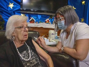 Gisèle Lévesque, 89, becomes the first Quebecer to receive the COVID-19 vaccine, in Quebec City on Dec. 14, 2020.
