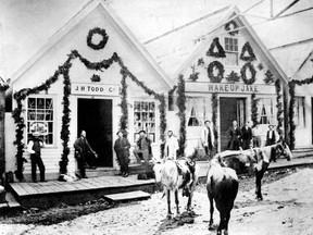 Barkerville, circa 1869. Photograph shows J.H. Todd Company and Wake-Up Jake decorated for Colonial B.C. Governor Anthony Musgrave's visit. AM54-S4-: Out P205