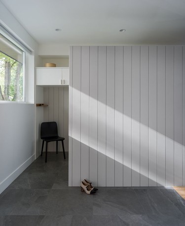 At the front of the home, architect Hitesh Neb designed mudroom set off by millwork to conceal shoes, coats, cleats, dance gear and other clutter.