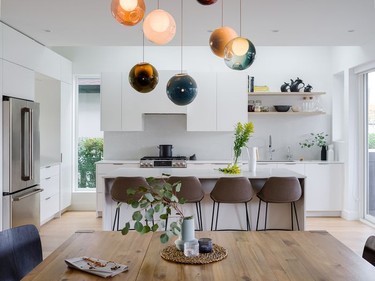 Light streams into the kitchen from all angles, including above, thanks to skylights made possible by the home's offset second storey.