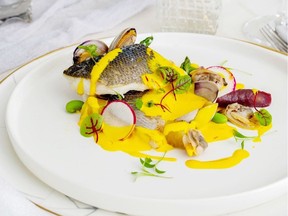 Branzino, clams and lemon saffron sauce created by Chef Jasmin Porcic of Edge Catering.