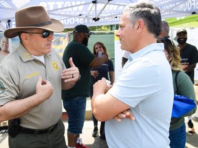 Los Angeles County Sheriff Alex Villanueva, left, speaks with Councilmember Joe Buscaino during the Watts Juneteenth Street Fair on June 19, 2021 in the Watts neighbourhood of Los Angeles, Calif.